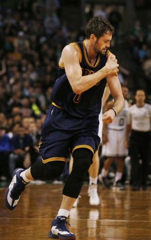 Cleveland Cavaliers forward Kevin Love runs off the floor holding his shoulder during the first quarter of a first-round NBA playoff basketball game in Boston, Sunday, April 26, 2015. Love dislocated his left shoulder and left the game. (Gus Chan/The Plain Dealer via AP) MANDATORY CREDIT NO SALES