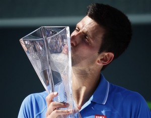 Novak Djokovic, of Serbia, kisses the trophy after he defeated Andy Murray, of Great Britain, during the men's final match at the Miami Open tennis tournament, Sunday, April 5, 2015, in Key Biscayne, Fla. Djokovic won 7-6 (3), 4-6, 6-0. AP PHOTO