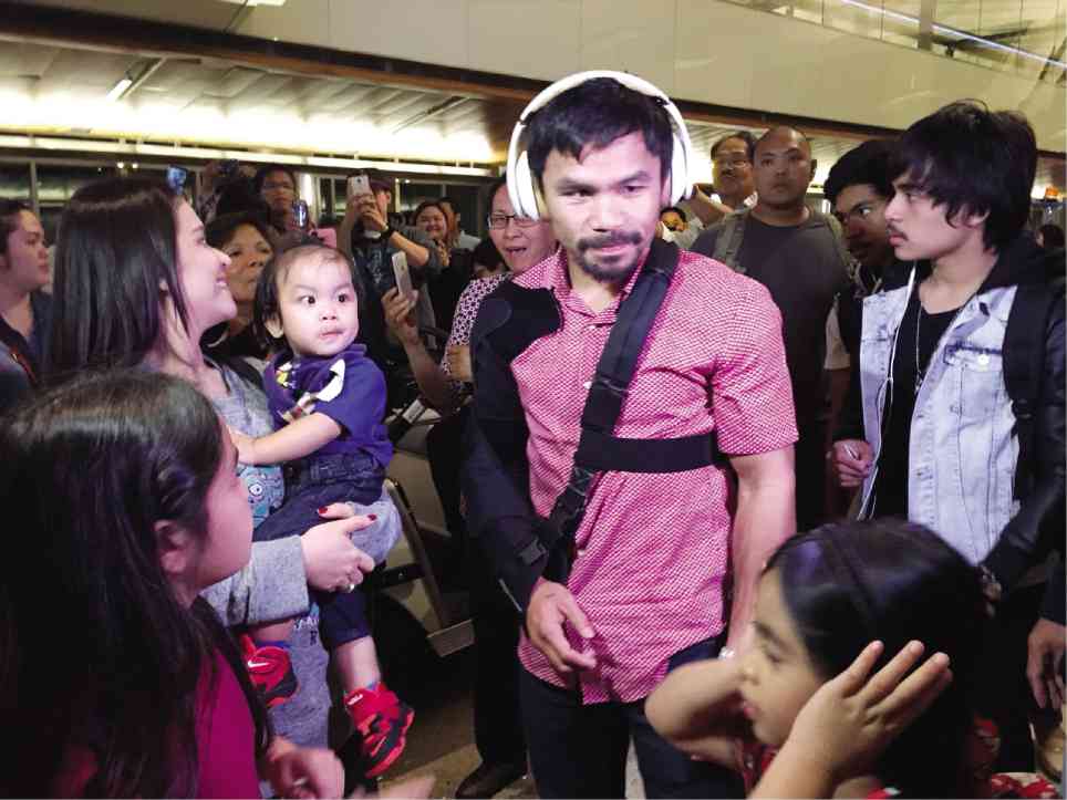 RETURNING HOME  Manny Pacquiao and his family board Philippine Airlines Flight PR103 in Los Angeles for their return flight to the Philippines after the boxer’s unsuccessful bid against world welterweight champion Floyd Mayweather Jr. The Pacquiaos are expected to arrive in Manila before dawn today. REM ZAMORA