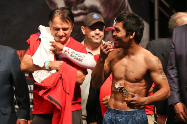 Manny Pacquiao eats a chocolate bar after his weigh in at the MGM Grand in Las Vegas, Nevada on Friday, 1 May 2015. PHOTO BY REM ZAMORA