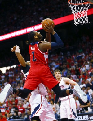 Washington Wizards guard John Wall (2) goes up for a shot against Atlanta Hawks Al Horford, left, and Kyle Korver in the second half of an NBA second-round basketball payoff series game, Sunday, May 3, 2015, in Atlanta. Washington won 104-98. (AP Photo/John Bazemore)