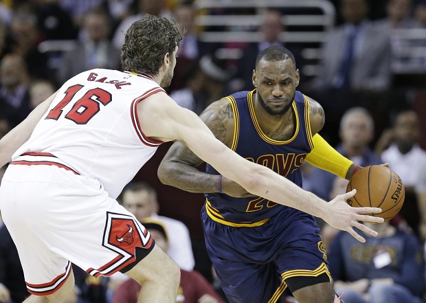 FILE - In this April 5, 2015, file photo, Cleveland Cavaliers' LeBron James, right, drives past Chicago Bulls' Pau Gasol (16), from Spain, during an NBA basketball game in Cleveland. On Monday, May 4, 2015, the Cavaliers, missing two starters, will open their best-of-seven Eastern Conference semifinals against a confident and finally healthy Chicago team looking to exact some revenge on James, who has eliminated them from the NBA playoffs three times since 2010. (AP Photo/Tony Dejak, File)