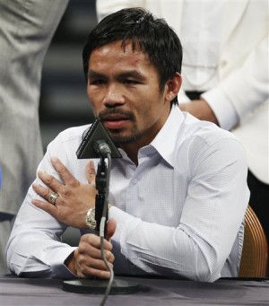 In this May 2, 2015 photo, Manny Pacquiao answers questions during a press conference following his welterweight title fight against Floyd Mayweather Jr. in Las Vegas. A class-action lawsuit has been filed by two Nevada men seeking millions in damages because they say he fraudulently concealed a shoulder injury before his defeat to Floyd Mayweather Jr.  AP PHOTO/JOHN LOCHER 