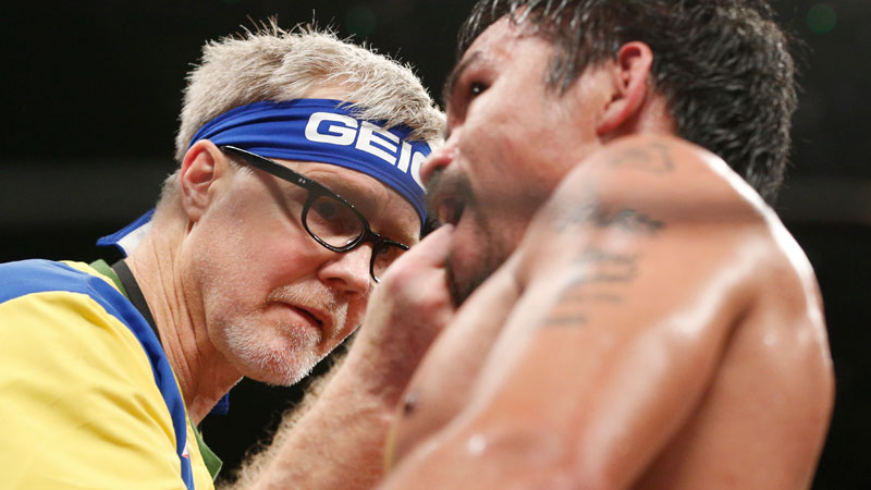 Trainer Freddie Roach, left, checks on Manny Pacquiao during his welterweight title fight against Floyd Mayweather Jr. on Saturday, May 2, 2015 in Las Vegas.  AP PHOTO/JOHN LOCHER
