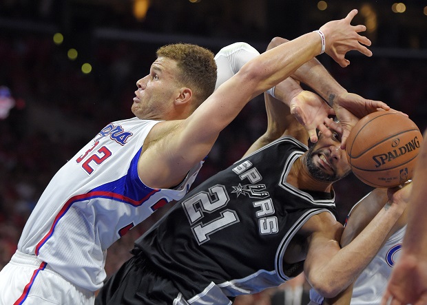 Los Angeles Clippers forward Blake Griffin, left, and San Antonio Spurs forward Tim Duncan battle for a rebound during the second half of Game 7 in a first-round NBA basketball playoff series, Saturday, May 2, 2015, in Los Angeles. The Clippers won 111-109. (AP Photo/Mark J. Terrill)