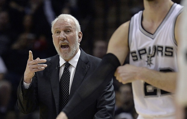 San Antonio Spurs head coach Gregg Popovich talks to his players during the first half of Game 3 in an NBA basketball first-round playoff series against the Los Angeles Clippers, Friday, April 24, 2015, in San Antonio. (AP Photo/Darren Abate)