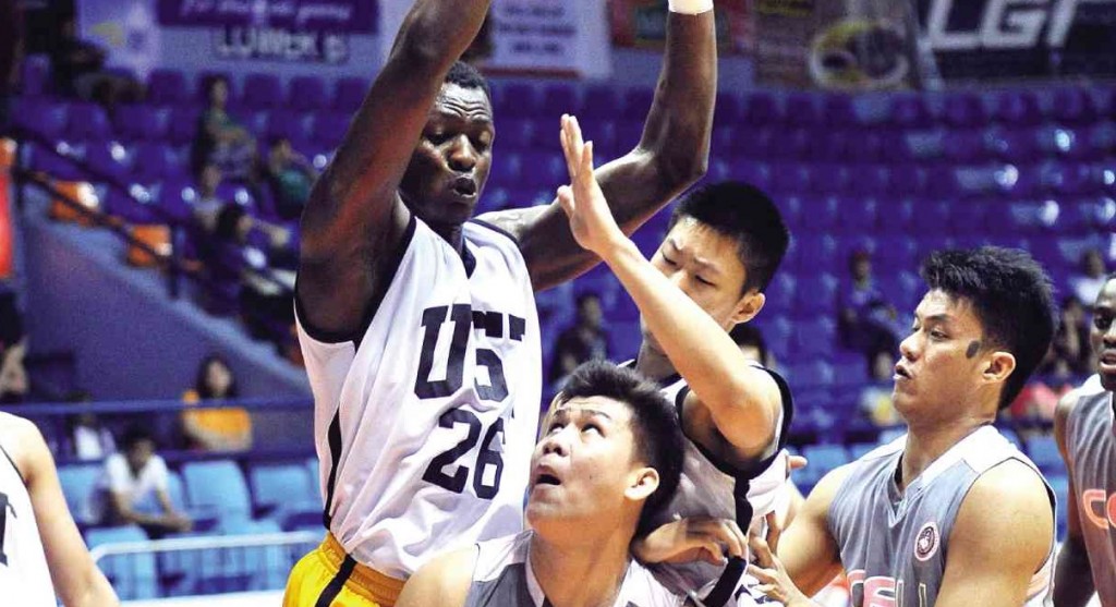 CARLO Casino of CEU (17) fakes off Zacgary Huang and Christian Kakonda of UST during their Filoil game yesterday. See story below.AUGUST DELA CRUZ