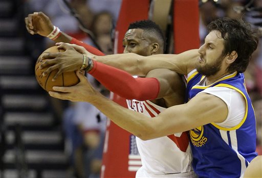 Houston Rockets center Dwight Howard, left, and Golden State Warriors center Andrew Bogut, right, go after a rebound during the first half in Game 3 of the NBA basketball Western Conference finals Saturday, May 23, 2015, in Houston. AP PHOTO