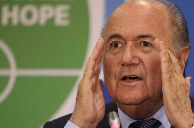 FILE - In this Tuesday, June 23, 2009 file photo FIFA president Sepp Blatter gestures as he speaks at the inaugural 'Football for Hope Forum', during the Confederations Cup soccer tournament, at a hotel in Vanderbijlpark, South Africa. (AP Photo/David Azia, File)