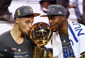 CLEVELAND, OH - JUNE 16: Stephen Curry #30 and Andre Iguodala #9 of the Golden State Warriors celebrate with the Larry O'Brien NBA Championship Trophy after defeating the Cleveland Cavaliers in Game Six of the 2015 NBA Finals at Quicken Loans Arena on June 16, 2015 in Cleveland, Ohio. NOTE TO USER: User expressly acknowledges and agrees that, by downloading and or using this photograph, user is consenting to the terms and conditions of Getty Images License Agreement.   Jason Miller/Getty Images/AFP