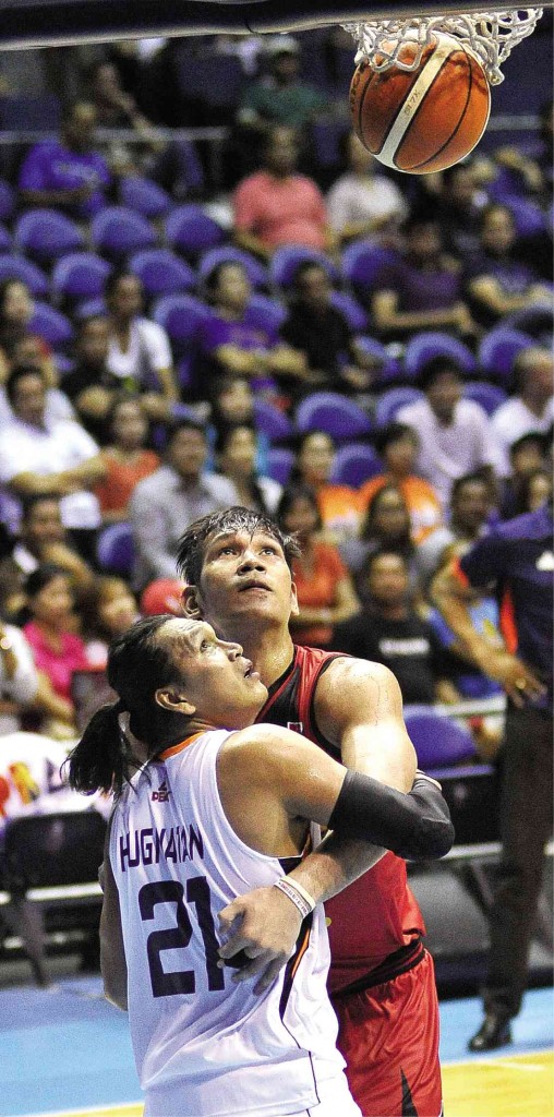 SAN MIGUEL Beer’s June Mar Fajardo and Meralco’s Reynel Hugnatan watch as an SMB basket goes in in last night’s game at the Big Dome. AUGUST DELA CRUZ 