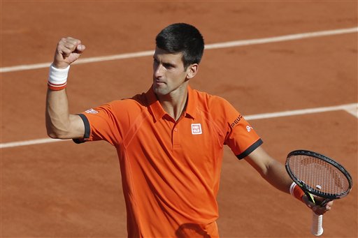 Serbia's Novak Djokovic celebrates winning the quarterfinal match of the French Open tennis tournament against Spain's Rafael Nadal in three sets, 7-5, 6-3, 6-1, at the Roland Garros stadium, in Paris, France, Wednesday, June 3, 2015. AP PHOTO