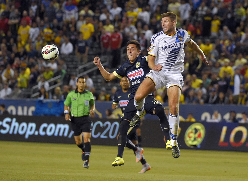 Club America's Francisco Rivvera, left, and Los Angeles Galaxy midfielder Steven Gerrard, of England, try to head the ball during the first half of an International Champions Cup soccer match, Saturday, July 11, 2015, in Carson, Claif. (AP Photo/Mark J. Terrill)