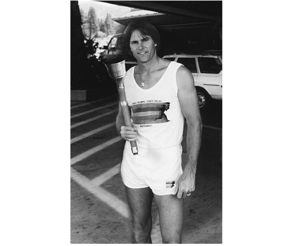 In this 1984 photo provided by Heritage Auctions, American Decathlete, Bruce Jenner poses with the 1984 Olympic Torch he carried through Lake Tahoe, Nevada. The 24-inch torch, featuring a brass finish and wood handle, is being offered by Heritage Auctions on July 30, 2015 at its Platinum Night Sports Auction in Chicago. It is the first significant piece of Jenner memorabilia to go to auction since the winner of the 1976 Olympic Decathlon Gold Medal became Caitlyn Jenner. (Heritage Auctions via AP)