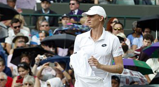 Kevin Anderson of South Africa arrives to resume his singles match against Novak Djokovic of Serbia, at the All England Lawn Tennis Championships in Wimbledon, London, Tuesday July 7, 2015. AP