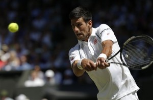 Novak Djokovic of Serbia returns a shot to  Richard Gasquet of France during the men's singles semifinal match at the All England Lawn Tennis Championships in Wimbledon, London, Friday July 10, 2015. AP PHOTO