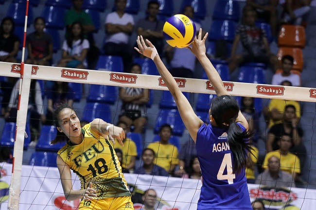 Guest player Jovelyn Gonzaga of FEU tries to get her spike through the defense of Arellano guest player Mina Aganon. Photo by Tristan Tamayo/INQUIRER.NET