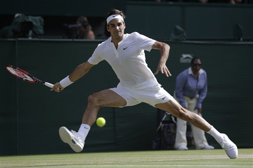 Roger Federer of Switzerland returns a shot to Andy Murray of Britain, during their men's singles semifinal match at the All England Lawn Tennis Championships in Wimbledon, London, Friday July 10, 2015. AP PHOTO