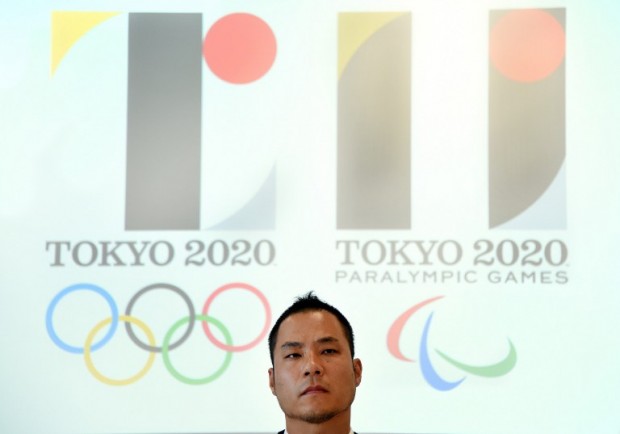 Tokyo Olympic logo designer Kenjiro Sano explains his design during a press conference at the headquarters of Tokyo 2020 in Tokyo on August 5, 2015.  Sano denied plagiarism claims after his emblem triggered threats of possible legal action in Europe.     AFP PHOTO / Toru YAMANAKA