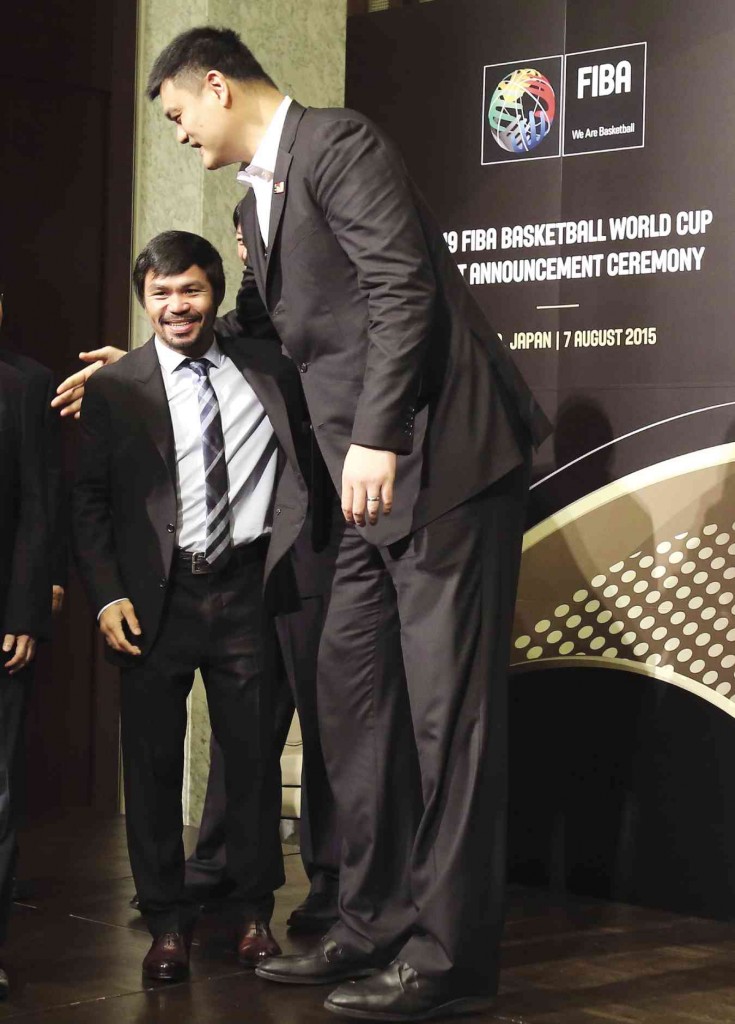 DAVID AND GOLIATH Eight-division world boxing champion Manny Pacquiao of the Philippines and China’s basketball superstar Yao Ming before the announcement of the 2019 Fiba Basketball World Cup host in Tokyo on Friday      AP 