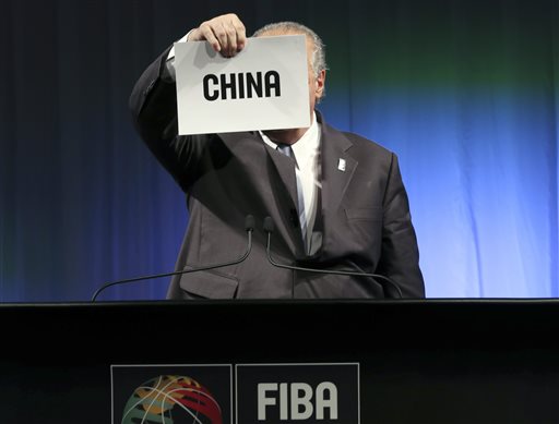 FIBA President Horacio Muratore shows the name of the country awarded to host the 2019 FIBA Basketball World Cup during a 2019 FIBA Basketball World Cup host announcement ceremony in Tokyo, Friday, Aug. 7, 2015. AP