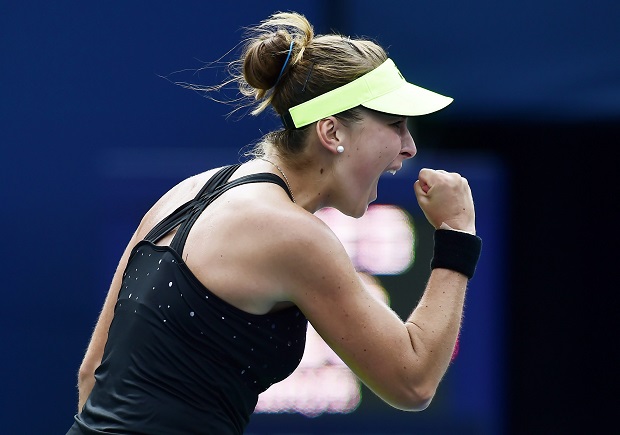 Belinda Bencic, of Switzerland, celebrates after winning the first set against Simona Halep, of Romania, during the women's final at the Rogers Cup tennis tournament in Toronto, Sunday, Aug. 16, 2015. (Frank Gunn/The Canadian Press via AP)