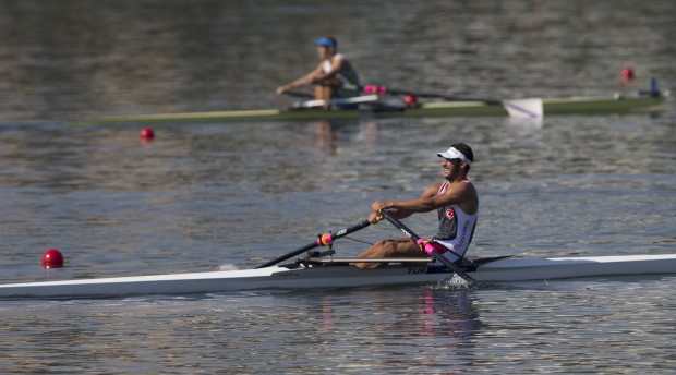 In this Aug. 5, 2015 photo, a rower from Turkey participates in the World Junior Rowing Championships on Rodrigo de Freitas lake in Rio de Janeiro, Brazil. The regatta took place just a week after The Associated Press published an independent five-month analysis of water quality that showed high levels of viruses and in some cases bacteria from human sewage in all of Rio's Olympic and Paralympic water venues, including the Rodrigo de Freitas _ the rowing venue.  (AP Photo/Silvia Izquierdo)