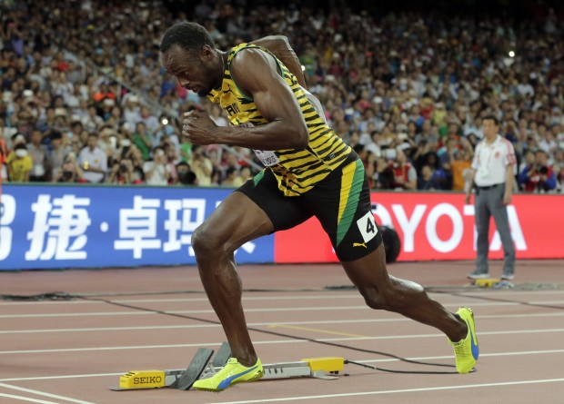 Jamaica's Usain Bolt starts a round one heat of the men’s 200m at the World Athletics Championships at the Bird's Nest stadium in Beijing, Tuesday, Aug. 25, 2015. (AP Photo/Andy Wong)