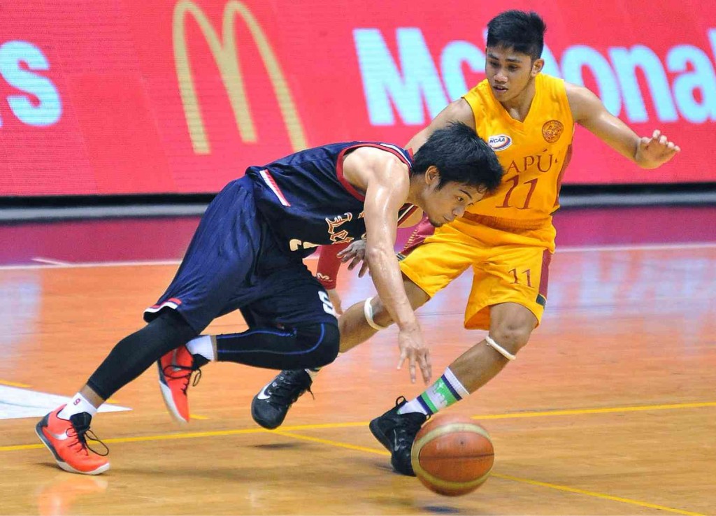 MARK Cruz (left) of the Letran Knights tries to dribble past John Nieles of the Mapua Cardinals during yesterday’s NCAA game. AUGUST DELA CRUZ