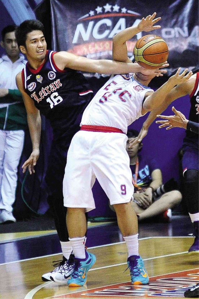 LETRAN’S Kevin Racal fouls Jose Morada of EAC as he tries to strip him of possession.  AUGUST DELA CRUZ