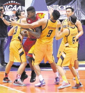 MAPUA’S Allwell Oraeme gets botted up in the paint by a Jose Rizal double team in yesterday’s game at Filoil Flying V Arena. AUGUST DELA CRUZ