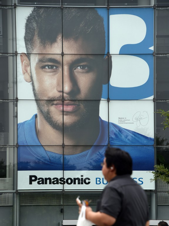 A Panasonic advertisement poster featuring Brazilian soccer star Neymar is displayed on the wall of the Panasonic Center in Tokyo on July 29, 2015. Neymar will miss Tuesday's European Super Cup in Tbilisi, Georgia, after contracting the mumps, Barcelona said Sunday, Aug. 9.  AFP PHOTO/TOSHIFUMI KITAMURA