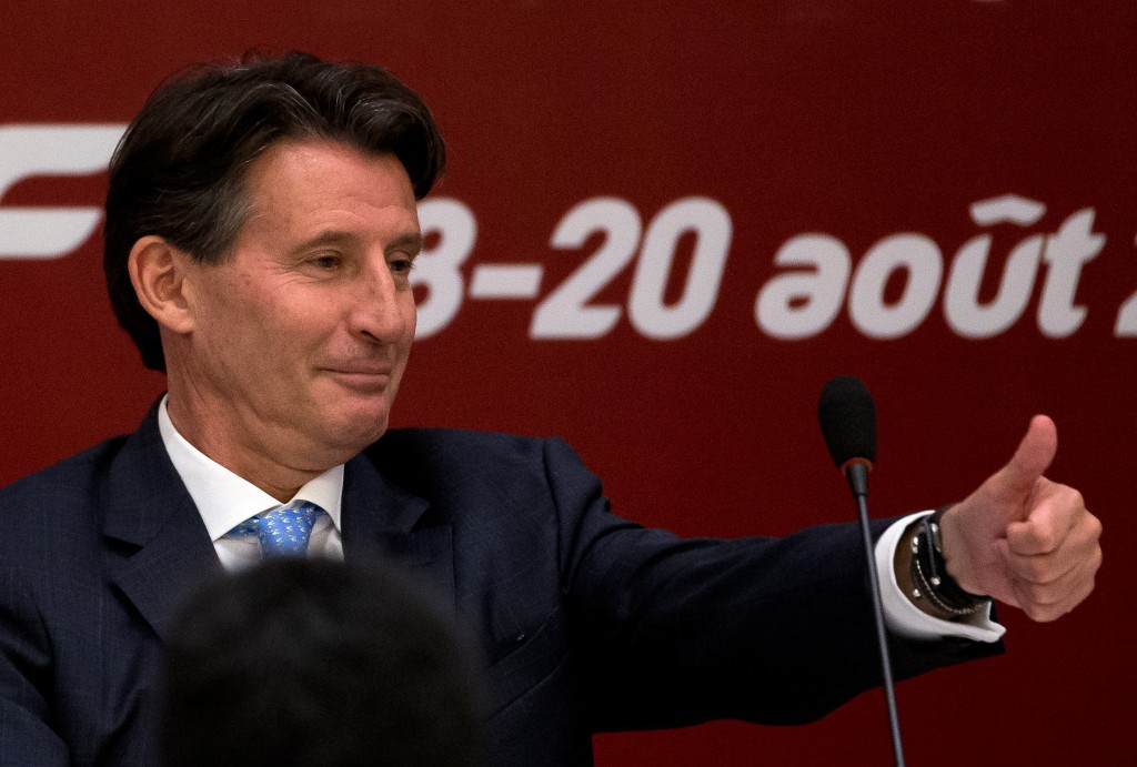 Sebastian Coe, newly elected International Association of Athletics Federations President gestures as he arrives on stage for a press briefing at the IAAF Congress at the National Convention Center in Beijing, Wednesday, Aug. 19, 2015. (AP Photo/Andy Wong)