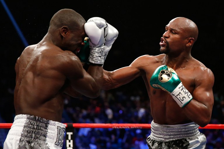 Floyd Mayweather Jr. throws a right at Andre Berto during their WBC/WBA welterweight title fight at MGM Grand Garden Arena on September 12, 2015 in Las Vegas, Nevada.   Ezra Shaw/Getty Images/AFP