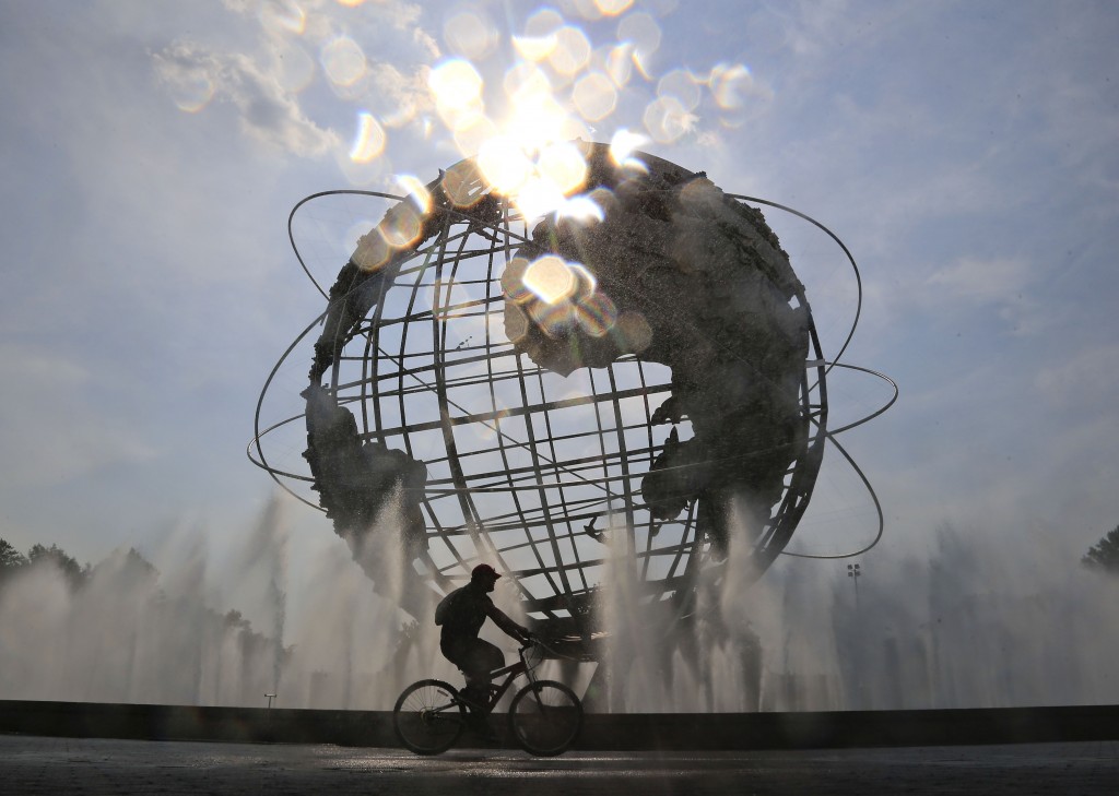 A cyclist passes the Unisphere inside Flushing Meadows Corona Park during the first round of the U.S. Open tennis tournament, Monday, Aug. 31, 2015, in New York. (AP Photo/Julio Cortez)