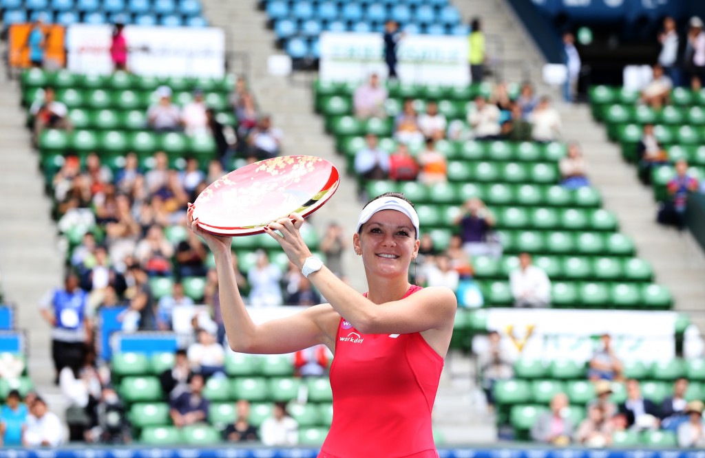Agnieszka Radwanska of Poland holds the champion trophy to celebrate after defeating Belinda Bencic of Switzerland in their women's singles final at the Pan Pacific Open women?s tennis tournament in Tokyo, Sunday, Sept. 27, 2015. (AP Photo/Eugene Hoshiko)