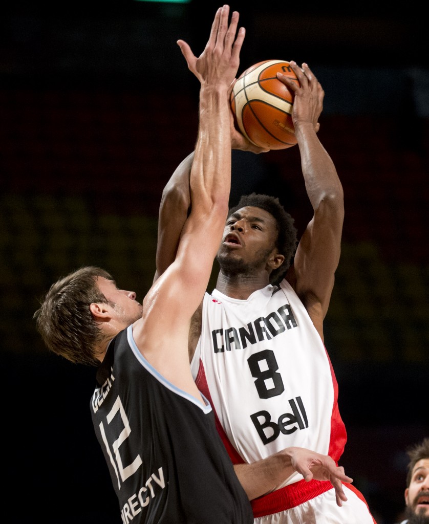 Canada's Andrew Wiggins, right, goes for a shot over Argentina's Marcos Delia during a FIBA Americas Championship basketball game in Mexico City, Tuesday, Sep. 1, 2015. AP