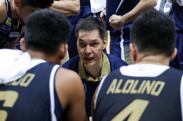 NU Bulldogs with head coach Eric Altamirano during the huddle. Photo by Tristan Tamayo/INQUIRER.net
