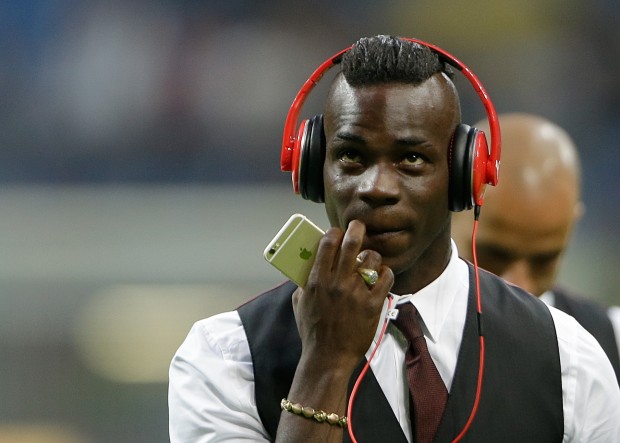 AC Milan's Mario Balotelli wears earphones prior to the start of a Serie A soccer match between Inter Milan and AC Milan, at the San Siro stadium in Milan, Italy, Sunday, Sept. 13, 2015. (AP Photo/Luca Bruno)