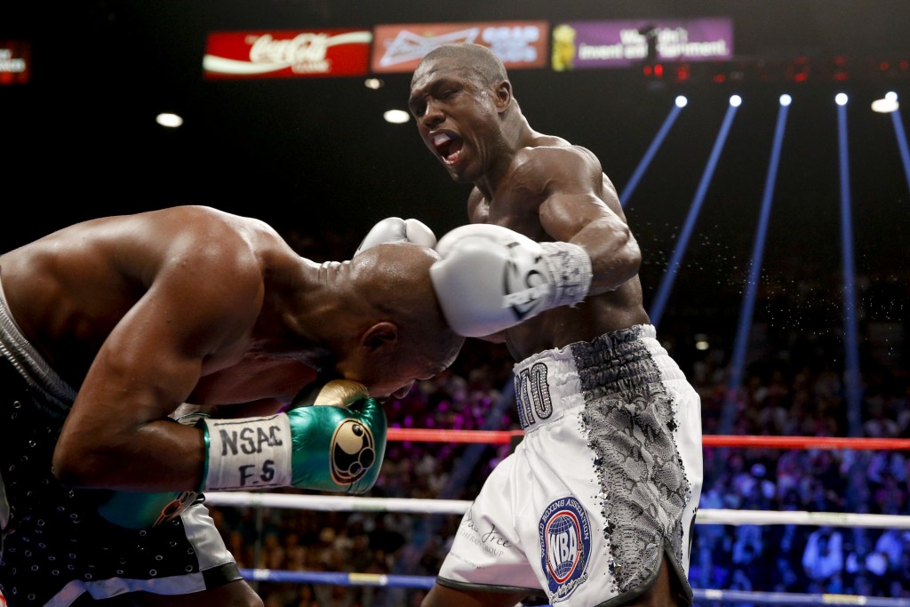 Andre Berto, right, punches Floyd Mayweather Jr. during their welterweight title fight Saturday, Sept. 12, 2015, in Las Vegas. Mayweather, who won the fight, ran his perfect record to 49-0, tying a mark set by the late heavyweight champion Rocky Marciano. (AP Photo/John Locher)