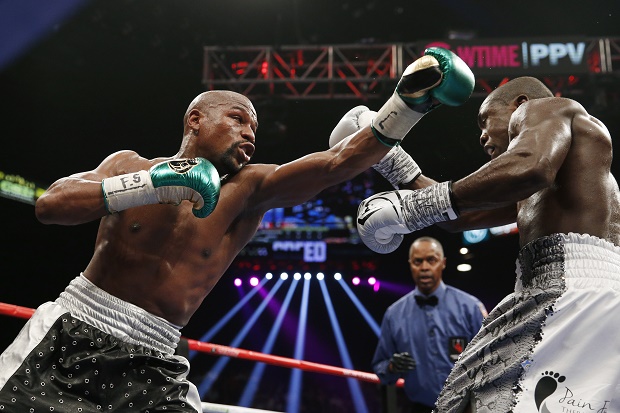 Floyd Mayweather Jr., left, throws a left at Andre Berto during their welterweight title boxing bout Saturday, Sept. 12, 2015, in Las Vegas. (AP Photo/John Locher)