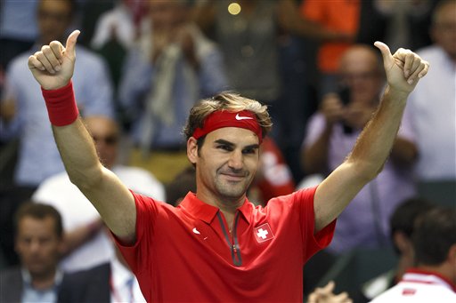 Roger Federer, of Switzerland, celebrates on the court after beating Thiemo De Bakker, of The Netherlands, giving Switzerland a 3-1 lead, after the third match of the Davis Cup World Group Play-off round match between Switzerland and Netherlands, in Geneva, Switzerland, Sunday, Sept. 20, 2015. AP 