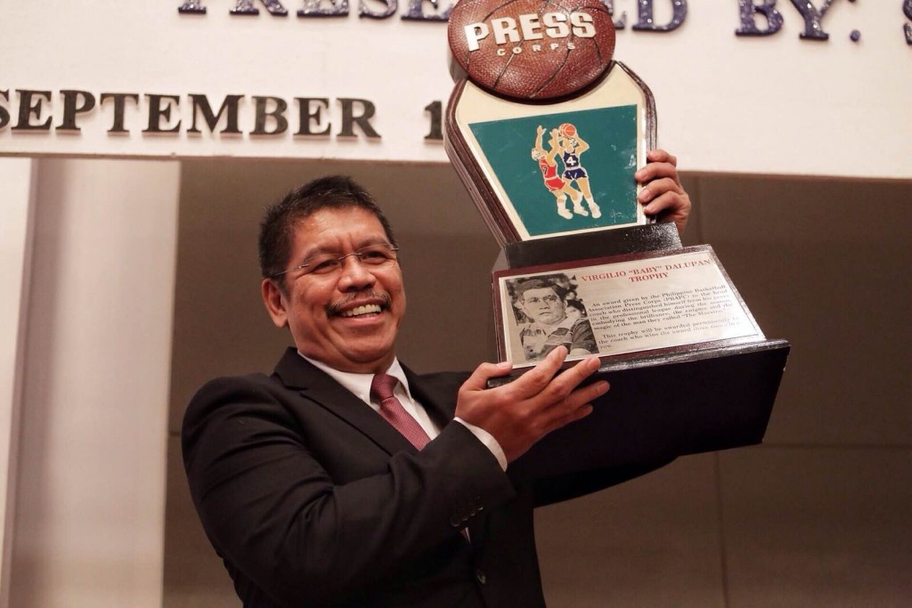 San Miguel coach raises his trophy during the awards night at the Century Park hotel. Photo by Tristan Tamayo/INQUIRER.net 