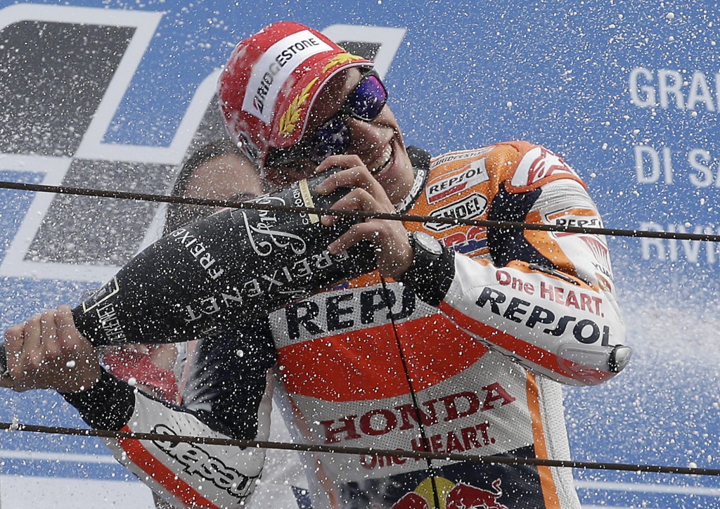 Honda rider Marc Marquez celebrates on the podium after winning the San Marino Moto GP grand prix. AP