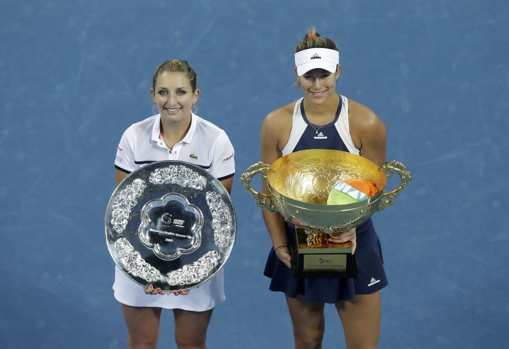 Garbine Muguruza of Spain and Timea Bacsinszky of Switzerland pose with their trophies after their women's singles final match in the China Open tennis tournament at the National Tennis Stadium in Beijing, Sunday, Oct. 11, 2015. Muguruza defeated Bacsinszky 7-5, 6-4.  (AP Photo/Andy Wong)