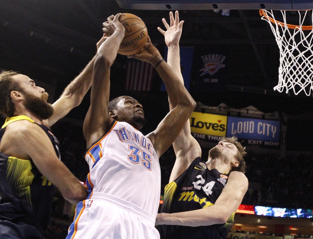 Oklahoma City Thunder forward Kevin Durant (35) shoots between Fenerbahce Ulker's Luigi Datome, left, and Jan Vesely (24) in the first quarter of an NBA basketball preseason game in Oklahoma City, Friday, Oct. 9, 2015. (AP Photo/Sue Ogrocki)