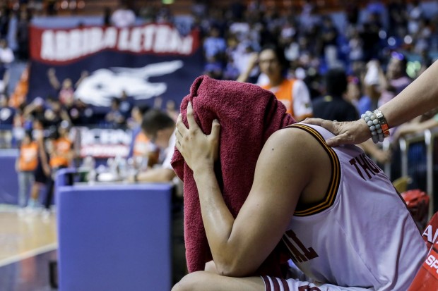 A crying Scottie Thompson stays hidden underneath a towel after a painful loss.  Photo by Tristan Tamayo/INQUIRER.net