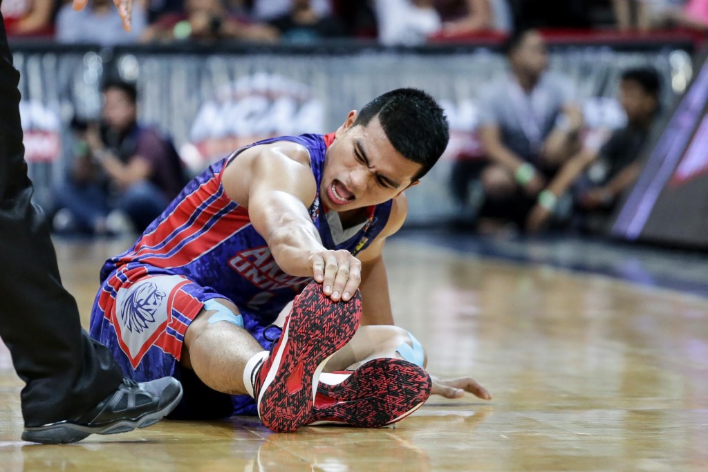 Jalalon stretches his legs after suffering from cramps late in a crucial game for Arellano. Photo by Tristan Tamayo/INQUIRER.net 