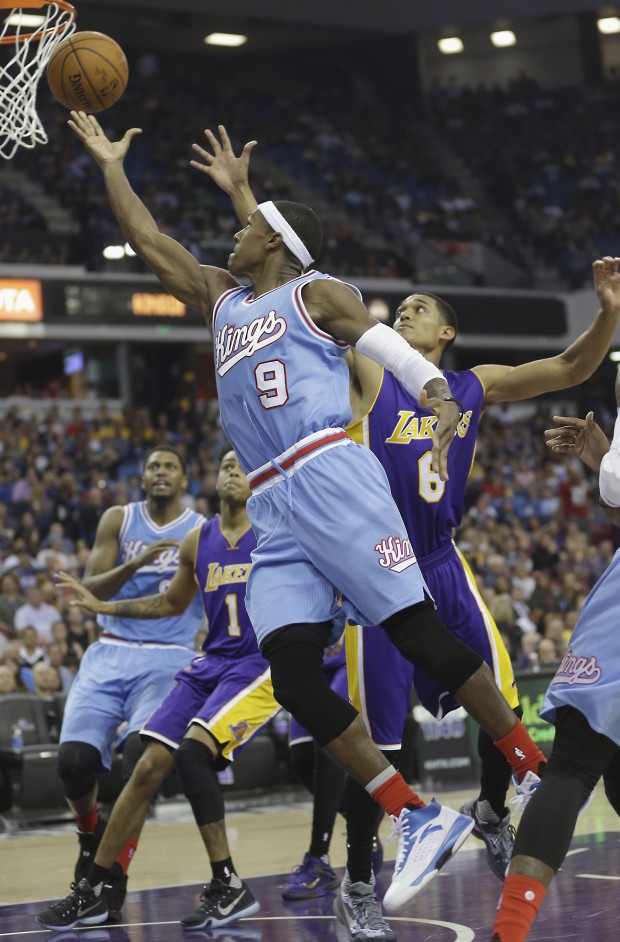 Sacramento Kings guard Rajon Rondo, left, drives to the basket against Los Angeles Lakers guard Jordan Clarkson during the second half of an NBA basketball game in Sacramento, Calif., Friday, Oct. 30, 2015. The Kings won 132-114. (AP Photo/Rich Pedroncelli)
