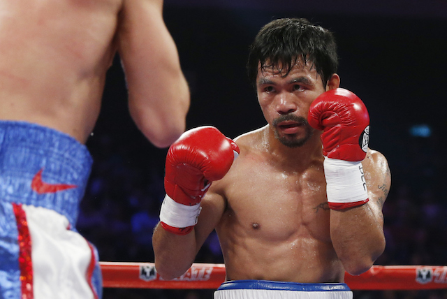 WBO welterweight champion Manny Pacquiao, right, of the Philippines, fights during his world welterweight title boxing match against WBO junior welterweight champion Chris Algieri of the U.S. at the Venetian Macao in Macau, Sunday, Nov. 23, 2014. AP